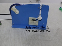 Máy quấn băng keo túi nilong trong siêu thị, máy buộc đầu túi Máy quấn băng keo túi nilong trong siêu thị, máy buộc đầu túi